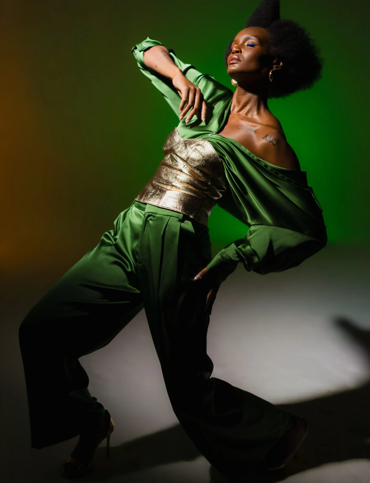 Expressive fashion portrait in green tailoring and metallic corset