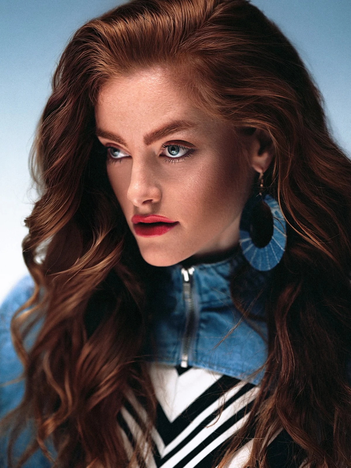 Fashion detail showing striped styling, denim and statement earrings